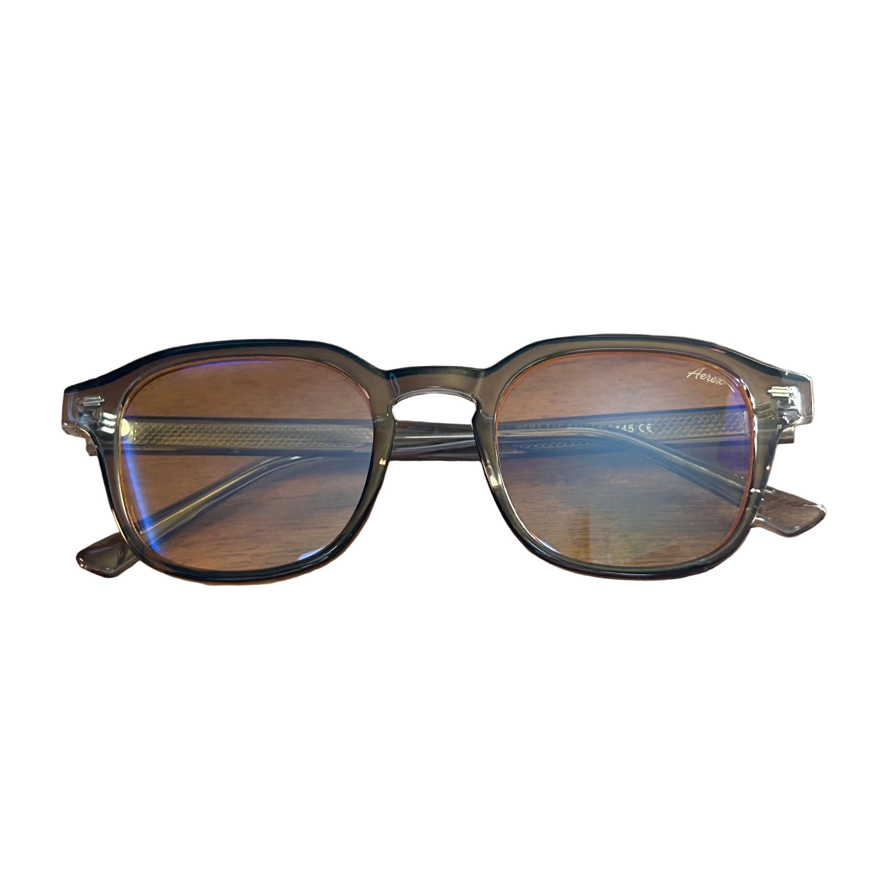Eyeglasses on a wooden surface with a white background